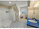 Bright bathroom with geometric floor tile, window seat, and vanity with blue countertop at 7 West St # C, Charleston, SC 29401