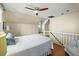 Cozy bedroom features a sloped ceiling, ceiling fan, and hardwood floors at 7 West St # C, Charleston, SC 29401
