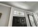 Close up of the front door with a stained glass window, sidelight, and wall mirror at 7 West St # C, Charleston, SC 29401