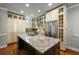 Spacious kitchen with a center island featuring granite counters, stainless steel appliances, and custom cabinetry at 7 West St # C, Charleston, SC 29401