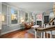 Bright living room with hardwood floors, fireplace, and shuttered windows at 7 West St # C, Charleston, SC 29401