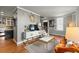 Open living room leading to kitchen, featuring hardwood floors and staircase at 7 West St # C, Charleston, SC 29401