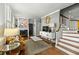 Open living room showcasing hardwood floors, fireplace, and elegant staircase at 7 West St # C, Charleston, SC 29401