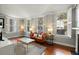 Sunlit living room with classic hardwood floors and neutral decor at 7 West St # C, Charleston, SC 29401