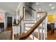 Staircase with wooden handrail and white risers leads to the upper level at 7 West St # C, Charleston, SC 29401