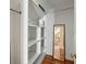 Walk-in closet with built-in shelving and a mirror reflecting a glimpse of the bedroom at 7 West St # C, Charleston, SC 29401