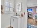 Bathroom vanity with storage, modern mirror and wood-look flooring at 739 Shamrock Ln, Charleston, SC 29412