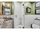 Green bathroom featuring a vanity with a black countertop and a walk-in shower at 739 Shamrock Ln, Charleston, SC 29412