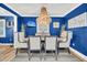 Elegant dining room with blue walls, modern chandelier, and seating for six at 739 Shamrock Ln, Charleston, SC 29412