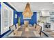 Elegant dining room with blue walls, modern chandelier, and view to the kitchen at 739 Shamrock Ln, Charleston, SC 29412