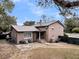 Charming home with a metal roof, brick exterior, and large backyard with stone patio at 739 Shamrock Ln, Charleston, SC 29412