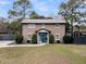 Charming brick two-story home with a metal roof, manicured front yard, and blue front door at 739 Shamrock Ln, Charleston, SC 29412