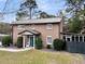 Attractive home with a bright blue door, a metal roof, and well-maintained landscaping at 739 Shamrock Ln, Charleston, SC 29412
