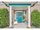 Inviting front porch featuring a colorful door, stylish furniture, and potted plants at 739 Shamrock Ln, Charleston, SC 29412