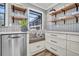 Bright kitchen featuring a window seat, open shelving, and stainless steel appliances at 739 Shamrock Ln, Charleston, SC 29412