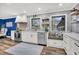 Modern kitchen featuring white cabinets, stainless steel appliances, and a cozy window seat bench at 739 Shamrock Ln, Charleston, SC 29412