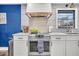 Well-equipped kitchen with stainless steel appliances, white cabinets, and a modern range hood at 739 Shamrock Ln, Charleston, SC 29412