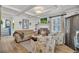 Cozy living room with a fireplace, wood floors, coffered ceilings, and two comfortable floral armchairs at 739 Shamrock Ln, Charleston, SC 29412