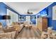 Spacious living room with a large sofa, ceiling fan, and a mounted television at 739 Shamrock Ln, Charleston, SC 29412