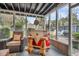 Fun sunroom with a whimsical bar, comfy chair, and access to the outdoor patio at 739 Shamrock Ln, Charleston, SC 29412