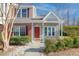 Charming townhouse featuring brick accents, red shutters, and a well-manicured front lawn at 7900 Shadow Oak Dr Dr, North Charleston, SC 29406