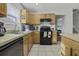 Well-lit kitchen featuring tiled floors and oak cabinets at 7900 Shadow Oak Dr Dr, North Charleston, SC 29406