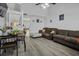 Open-concept space featuring laminate flooring, a vaulted ceiling, and easy access to other rooms at 7900 Shadow Oak Dr Dr, North Charleston, SC 29406