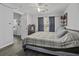 Comfortable bedroom showcasing laminate flooring, a fan, and plenty of sunlight at 7900 Shadow Oak Dr Dr, North Charleston, SC 29406