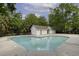 Community pool with a pool house surrounded by lush trees at 7900 Shadow Oak Dr Dr, North Charleston, SC 29406