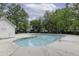 Community pool with a pool house surrounded by lush trees and green grass at 7900 Shadow Oak Dr Dr, North Charleston, SC 29406