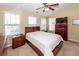 Bright main bedroom featuring a ceiling fan and three large windows at 81 Branch Creek Trl, Summerville, SC 29483