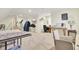 Spacious basement with carpet flooring, multiple work areas, and a sewing machine at 8656 Laurel Grove Ln, North Charleston, SC 29420