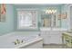 Bright bathroom with a large soaking tub and a double vanity at 8656 Laurel Grove Ln, North Charleston, SC 29420