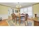 Formal dining room with wood floors, decorative rug, and a traditional chandelier at 8656 Laurel Grove Ln, North Charleston, SC 29420