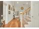 Bright foyer with hardwood floors, staircase, and a view into the living area at 8656 Laurel Grove Ln, North Charleston, SC 29420
