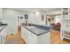 Open kitchen with a sink, white appliances, and hardwood floors at 8656 Laurel Grove Ln, North Charleston, SC 29420