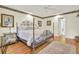 Bedroom with a four-poster bed, wood floors, and decorative accents at 8656 Laurel Grove Ln, North Charleston, SC 29420