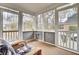 Relaxing screened porch featuring a wicker chair and view of the backyard at 8656 Laurel Grove Ln, North Charleston, SC 29420