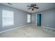 Bedroom featuring carpet floors, grey walls, and two windows at 8857 Gable St, North Charleston, SC 29406