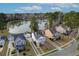 Picturesque neighborhood featuring a tranquil lake and well-maintained homes in a lush, wooded area at 8957 N Red Maple Cir, Summerville, SC 29485