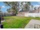 Well-maintained backyard features a storage shed and a partial view of the lake at 8957 N Red Maple Cir, Summerville, SC 29485