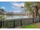 Enjoy serene lake views from the backyard, enclosed by a charming black picket fence at 8957 N Red Maple Cir, Summerville, SC 29485