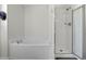 Bathroom features a separate shower and tub, with bright white tiles at 8957 N Red Maple Cir, Summerville, SC 29485