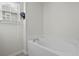 A soaking tub is positioned beneath a window with white blinds, offering a relaxing bathing space at 8957 N Red Maple Cir, Summerville, SC 29485