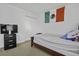 Bright bedroom featuring a single bed, TV atop a dresser, closet, and Mexican flag at 8957 N Red Maple Cir, Summerville, SC 29485