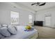 Bedroom features a tray ceiling, ceiling fan, two large windows, and ensuite access to the backyard at 8957 N Red Maple Cir, Summerville, SC 29485