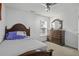 Cozy bedroom showcasing a bed, dresser with mirror, ceiling fan, and bright window at 8957 N Red Maple Cir, Summerville, SC 29485