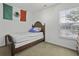 Sunlit bedroom with a bed, window view, and a Mexican flag above the bed at 8957 N Red Maple Cir, Summerville, SC 29485