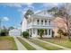Charming two-story home featuring a double balcony and detached garage with a well-manicured front yard at 8957 N Red Maple Cir, Summerville, SC 29485