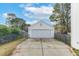 A detached white garage with a concrete driveway offers convenient parking and storage at 8957 N Red Maple Cir, Summerville, SC 29485